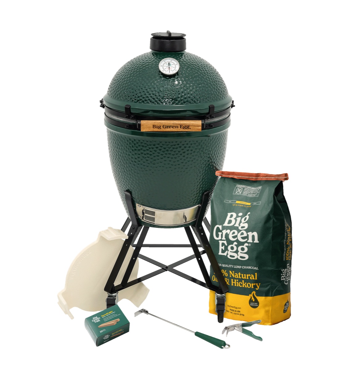 Big Green Egg Large in Nest Package on a white background: the green Large EGG standing in its black metal Nest, with convEGGtor, lump charcoal, starters and tools